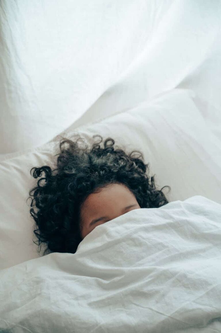 woman with covers over her head