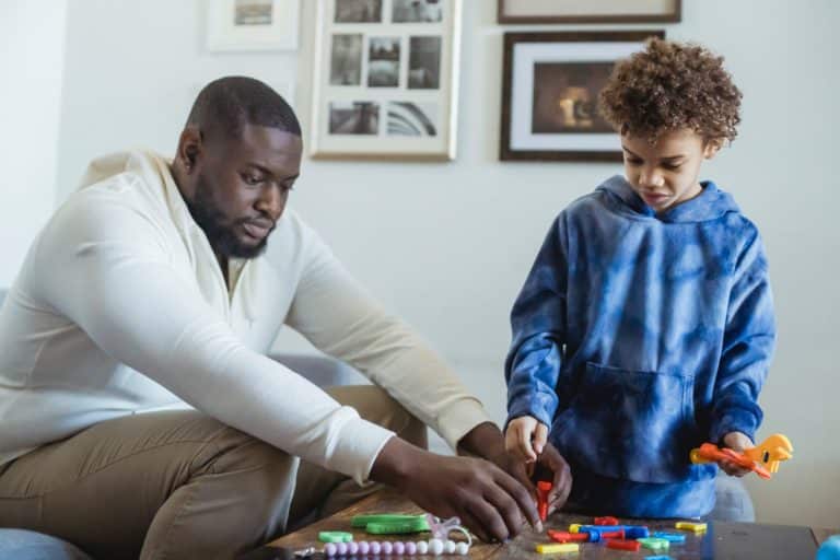 black father and son playing with toy instruments