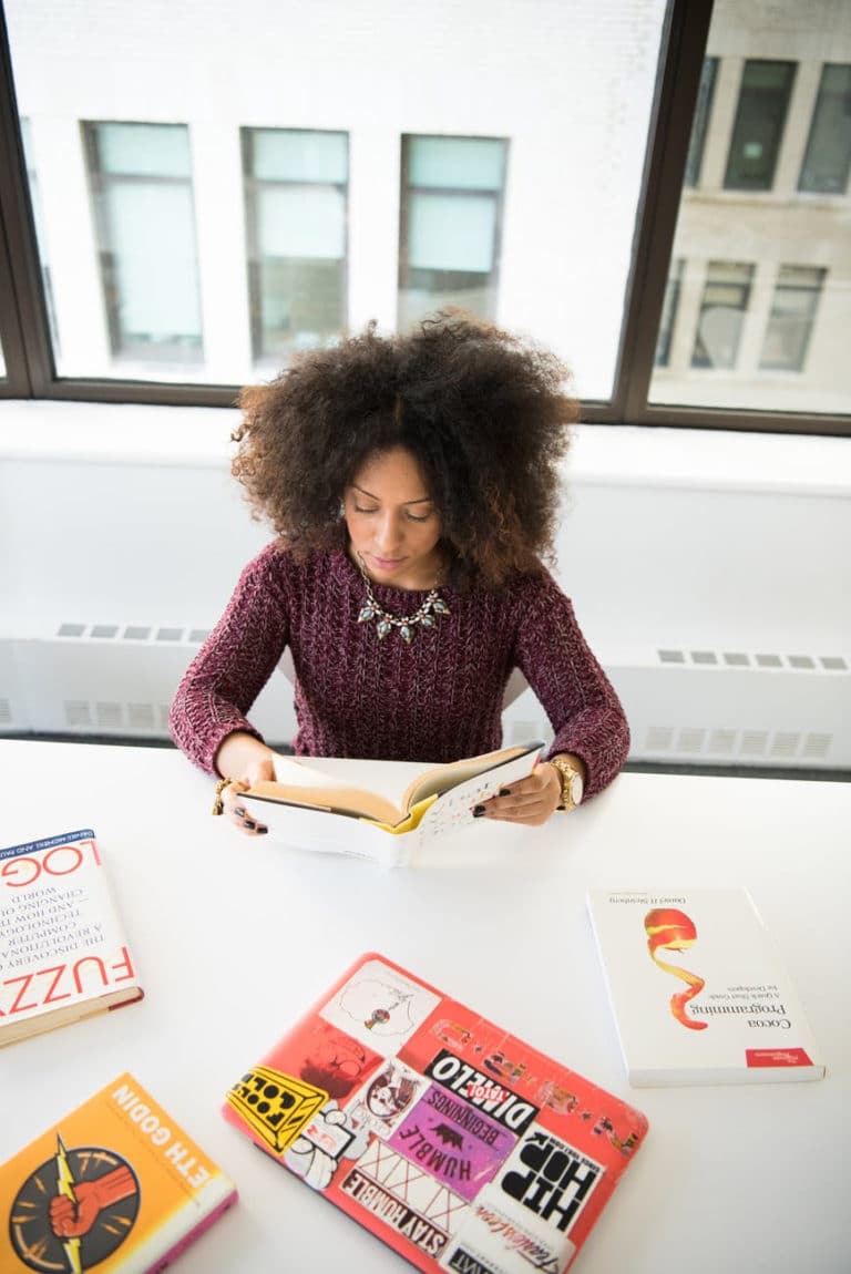 Black woman reading many books