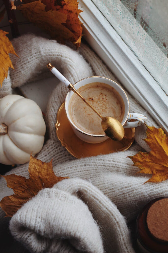 Fall drink surrounded by white gourds